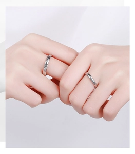 Close-up of S925 silver couple rings with 'Only love you' engraving on hands