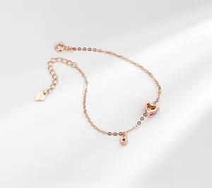 Close-up of rose gold S925 sterling silver heart bracelet with adjustable clasp and tag