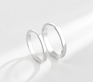 Macro shot of polished S925 sterling silver couple rings with smooth mirror finish