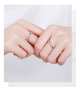 Close-up of S925 sterling silver couple rings set with minimalist textured design