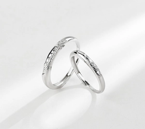 Macro detail of S925 sterling silver couple rings showing mountain and moon textures