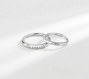 Detailed macro view of S925 sterling silver couple rings with relief mountain ocean patterns