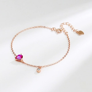 Rose gold silver bracelet with heart-shaped red gemstone and white zircon charm
