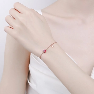 Elegant rose gold heart pendant bracelet with red stone and sterling silver chain for women