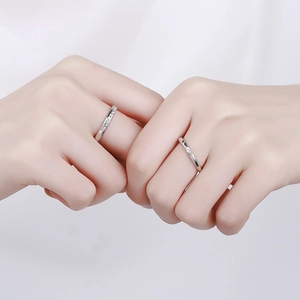 Matching S925 sterling silver couple rings with engraved texture and small diamond accent