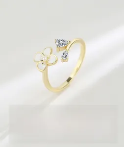 Detail of adjustable S925 silver ring featuring white flower and sparkling zircons