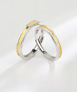 Macro view of S925 sterling silver couple rings with gold textured finish and engraving