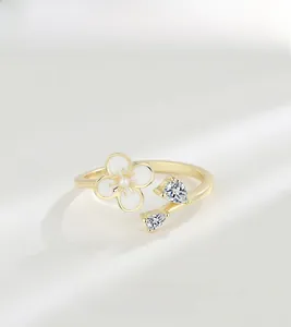 Detail of S925 silver flower ring with white petals and sparkling cubic zirconia stones