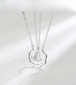 Detail of S925 sterling silver sailboat pendant with sparkling cubic zirconia inlay