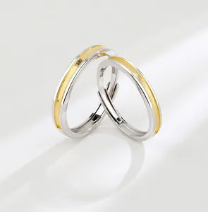 Macro detail of S925 sterling silver couple rings showing the S925 hallmark and gold inlay
