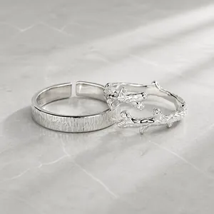 Macro shot of S925 sterling silver couple rings with tree bark and twig branch textures