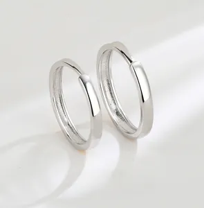 Detailed macro shot of hand-polished silver couple rings with a smooth glossy finish