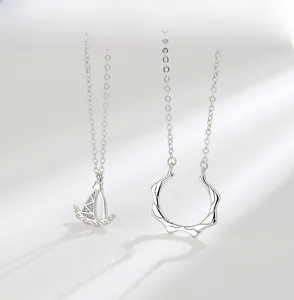 Detail of S925 sterling silver sailboat and wave circle pendants on thin O-chains