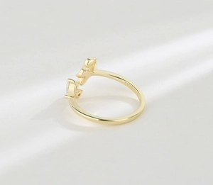 Macro detail of S925 sterling silver stamp on golden flower ring with zircon gemstone