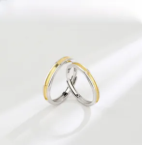 Macro shot of S925 sterling silver couple rings showing brushed gold texture and S925 hallmark