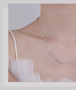 Detail of S925 sterling silver paperclip chain necklace on woman's neckline