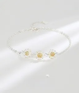 Detailed macro view of S925 silver daisy bracelet with three flowers and heart tag