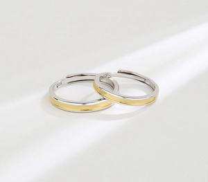 Macro detail of S925 sterling silver couple rings with gold textured finish and inner stamp