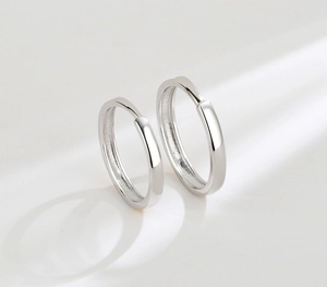 Detailed close-up showing high-polished finish on minimalist sterling silver hoop earrings
