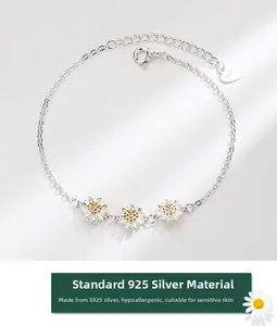 Macro detail of S925 sterling silver daisy bracelet with gold accents and heart charm
