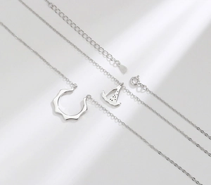 Detail view of S925 sterling silver sailboat necklace with wave ring and spring clasp