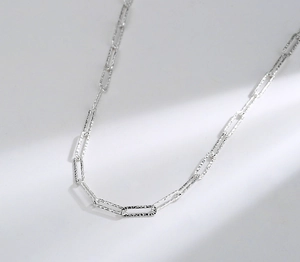 Macro shot of S925 sterling silver paperclip chain featuring hammered texture details