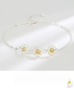 Close-up of S925 sterling silver daisy bracelet with gold centers and heart charm