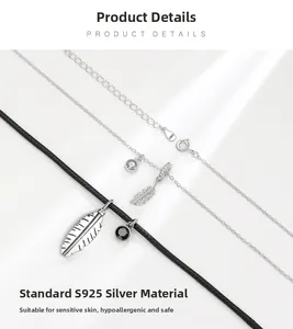 Detailed view of S925 sterling silver feather pendants with cubic zirconia inlay