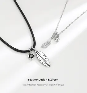 Detail showing silver feather necklaces with cubic zirconia in black cord and silver chain styles