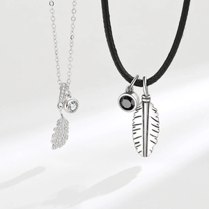 Matching feather pendant necklaces for couples with silver chain and black leather cord