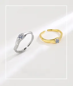 Detailed shot of irregular wavy silver and gold rings with round cubic zirconia stone