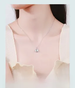 Close-up of S925 sterling silver cat planet necklace with iridescent gemstone on model