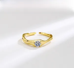 Detailed macro view of the gold-plated irregular wavy ring with a clear zircon stone