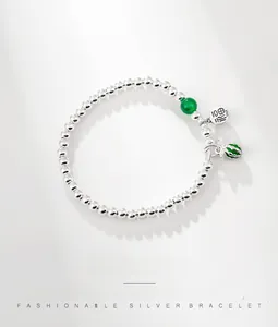 Detailed macro view of S925 sterling silver beads with green bead and Fu character charm