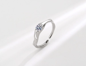 Close-up of S925 sterling silver irregular wavy ring with a sparkling round zircon