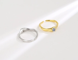 Macro shot of S925 sterling silver irregular ring and gold cubic zirconia band