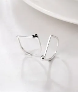 Macro detail of S925 sterling silver square open rings with flower and bead accents