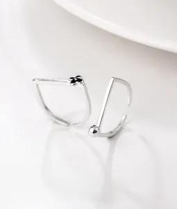 Macro detail of S925 sterling silver square rings featuring flower and ball motifs