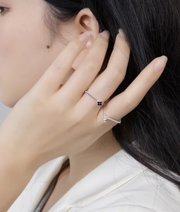 Close-up of S925 sterling silver stacked rings with black clover and V-shape design