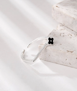 Detail showing the S925 sterling silver hallmark and black clover pattern on square ring