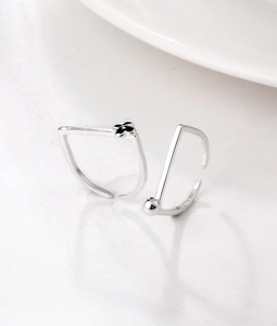 Macro shot of S925 sterling silver rings with black clover detail and minimalist beads
