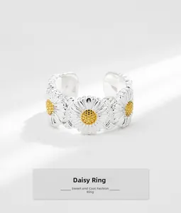 Detailed close-up of S925 silver daisy flower ring with golden center and open band