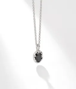 Close-up of S925 silver necklace featuring a polished oval black zircon pendant charm