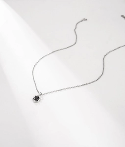 Macro detail of S925 sterling silver chain with a round black zircon stone pendant