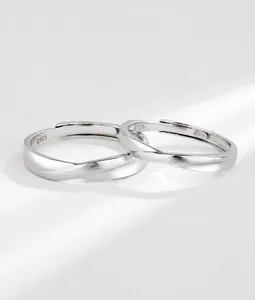 Macro detail of S925 sterling silver couple rings showing brushed and polished metal knot