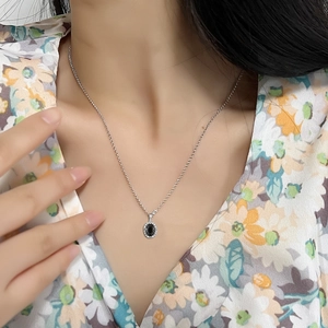 Minimalist S925 silver necklace with oval black zircon pendant shown on female model