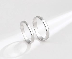 Polished S925 sterling silver couple rings showing minimalist knot design on white background