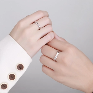 Minimalist S925 sterling silver couple knot rings with a brushed finish on human hands