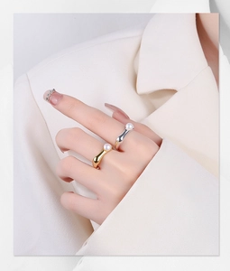 Macro detail of minimalist S925 silver pearl rings in gold and silver irregular finishes