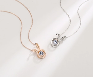 Macro shot of S925 silver rabbit pendant with dancing stone in rose gold and silver